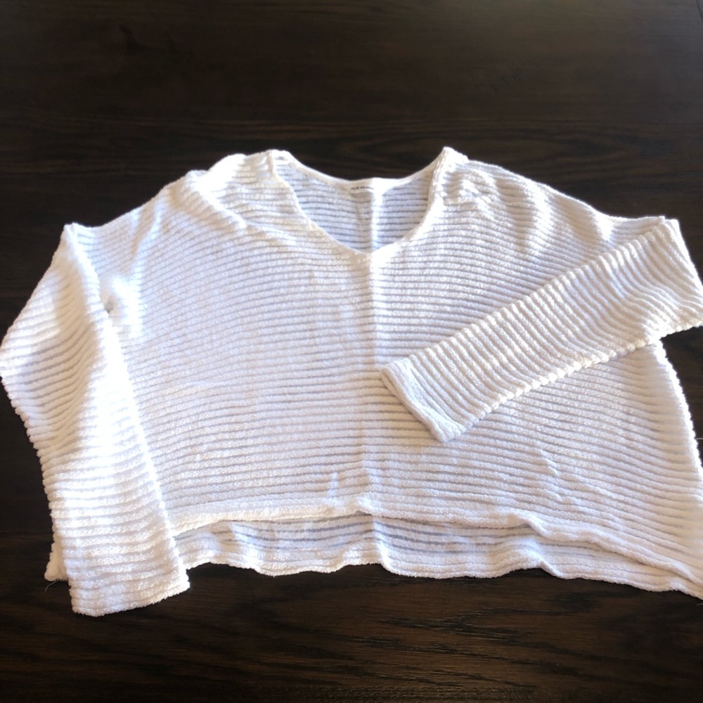 White sweater with sheer detailing.
